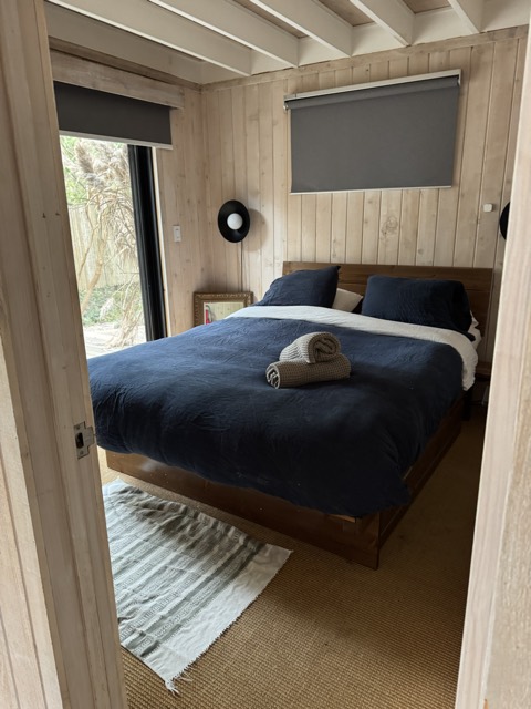 Bedroom with fresh navy bedding after cleaning