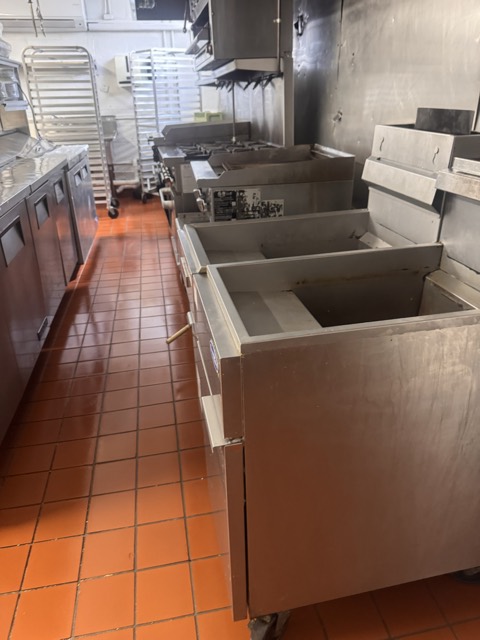 Commercial kitchen fryers and prep tables