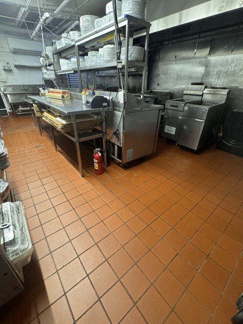 Commercial kitchen with tile floor and stainless equipment