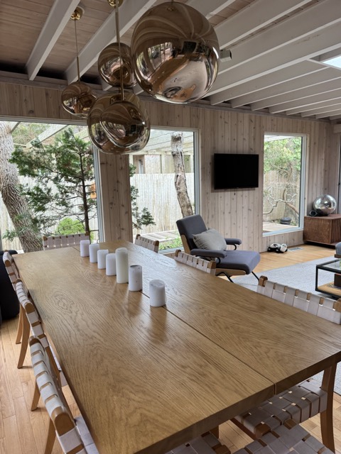 Dining room and long wooden table cleaned and reset