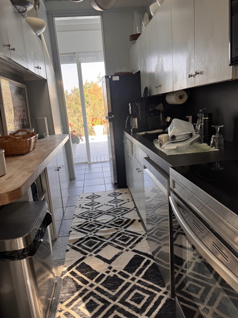 Galley kitchen with patterned tile floor after cleaning