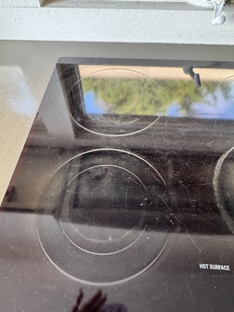 Close-up of a glass cooktop during deep cleaning