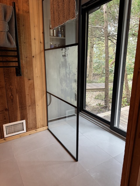 Glass shower and tile floor after bathroom cleaning