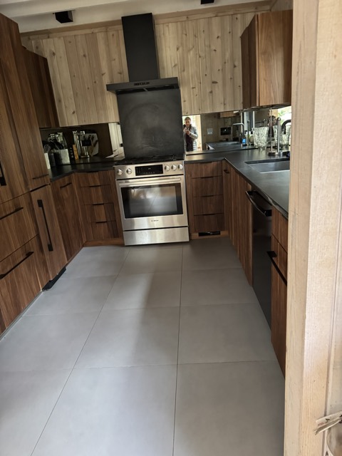 Kitchen with spotless tile floor and stainless range