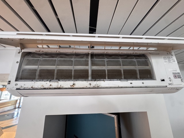 Wall AC unit opened up for filter cleaning
