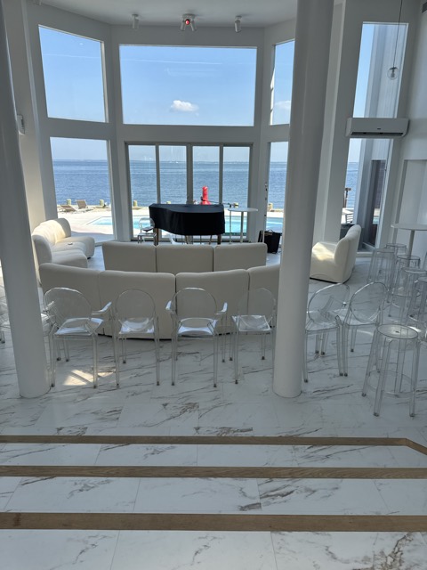 Waterfront living room with white marble floors, cleaned