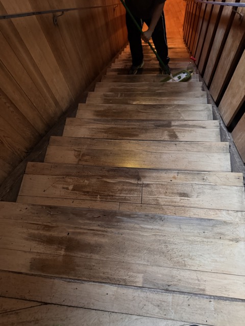 Wooden stairs being cleaned step by step